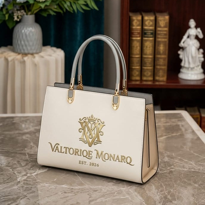 White handbag with gold logo and text on a marble surface, with a bookshelf and decorative items in the background.