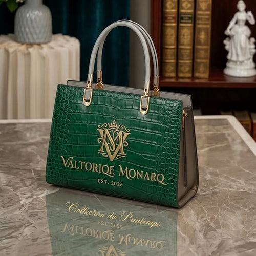 Green handbag with gold accents on a reflective surface, with a bookshelf and decorative items in the background.